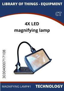 Tech Magnifying Lamp A 4X LED magnifying lamp with an adjustable neck, resting on a sturdy base, labeled as part of a library's equipment.